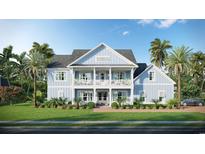 Beautiful two-story blue home with a covered porch and manicured lawn, surrounded by tropical palm trees at 8001 Mcsweeney Ct., Myrtle Beach, SC 29588