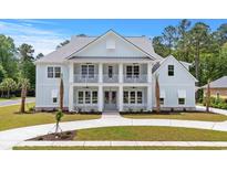 Stunning two-story home featuring double balconies, well-manicured lawn and mature landscaping at 8001 Mcsweeney Ct., Myrtle Beach, SC 29588