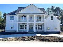 Beautiful two-story home featuring a double balcony, white siding, and a modern design at 8001 Mcsweeney Ct., Myrtle Beach, SC 29588