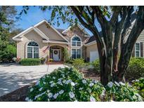 Charming home showcasing manicured landscaping and a welcoming front entrance at 1716 Club Circle Dr., Pawleys Island, SC 29585
