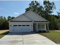Inviting exterior showcasing a charming home with a two-car garage and a well-maintained lawn at 3162 Wayside Rd., Conway, SC 29527