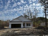 Charming single-story home with a two-car garage on a spacious lot with plentiful trees at 3162 Wayside Rd., Conway, SC 29527