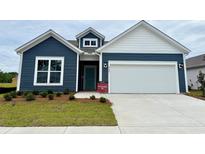 Charming home featuring navy blue siding, a two-car garage, and a well-maintained front lawn at 8640 Farrier Dr., Myrtle Beach, SC 29588