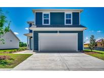 Two car garage with blue siding and manicured lawn at 8648 Farrier Dr., Myrtle Beach, SC 29588
