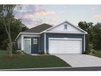 Charming home featuring a two-car garage, blue siding, and manicured landscaping at 4009 Braid Ct., Myrtle Beach, SC 29588
