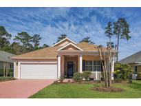 Charming single-story home with a manicured lawn, attached garage, and welcoming front porch at 1026 Nittany Ct., Murrells Inlet, SC 29576