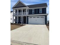 Charming two-story home with a large front-facing garage and second story balcony at 5015 Cambria Ct., Little River, SC 29566