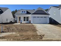 Charming single-Gathering home with a white exterior, a two-car garage, and newly installed cement driveway at 5040 Cambria Ct., Little River, SC 29566