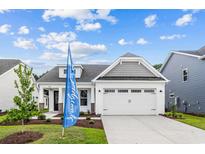 Charming single-Gathering home with a two-car garage and a beautifully landscaped front yard at 5040 Cambria Ct., Little River, SC 29566