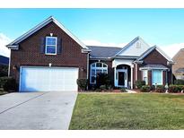 Charming red brick home with a well-manicured lawn and a spacious two-car garage at 1066 Brentford Pl., Myrtle Beach, SC 29579