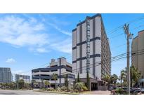A multi-story condo complex featuring neutral toned exteriors with an attached parking deck at 5308 N Ocean Blvd. # 1014, Myrtle Beach, SC 29577