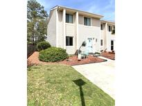 Charming two-story condo featuring a quaint patio area and well-maintained landscaping at 951 Plantation Dr. # F1, Little River, SC 29566
