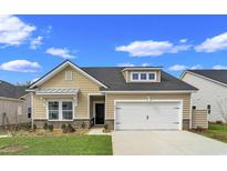 Beautiful Craftsman style home with a two-car garage and landscaped lawn at 9727 Indigo Creek Blvd., Murrells Inlet, SC 29576