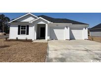 Charming single-story home with white siding and a spacious three-car garage at 1534 Clubstone Dr., Conway, SC 29526