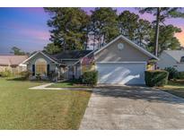 Charming single-story home featuring a well-manicured lawn and an attached two-car garage at 603 Bucks Trail, Longs, SC 29568