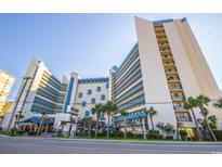 Beautiful exterior view of this multi-story condo building with tropical landscaping and street view at 7100 N Ocean Blvd. # 1421, Myrtle Beach, SC 29572