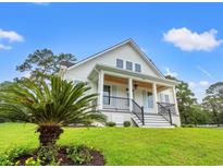Inviting two-story home with a charming front porch and well-manicured lawn at 805 Comanders Island Rd., Georgetown, SC 29440