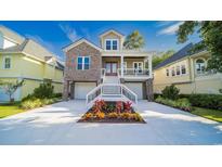 Beautiful two-story home with a brick facade, double garage, and charming front porch at 1010 Club House Dr., North Myrtle Beach, SC 29582