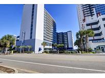 A wide street view of the BlueWater Resort in Myrtle Beach, SC, a modern building with palm trees at 2001 S Ocean Blvd. # 905, Myrtle Beach, SC 29577