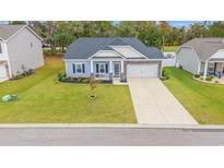 Charming single-Gathering home with a well-manicured lawn and a two-car garage at 131 Grissett Lake Dr., Conway, SC 29526