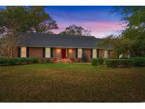 Brick ranch house with a spacious lawn and mature trees at 2221 Rosebud Dr., Conway, SC 29526