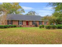 Charming brick home featuring a well-maintained front yard and a welcoming red front door at 2221 Rosebud Dr., Conway, SC 29526