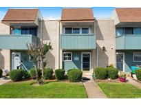 Brick townhome with teal accents and well-maintained landscaping at 4701 N Kings Hwy. # 6, Myrtle Beach, SC 29577
