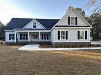 Charming new construction home with white siding, black shutters, and a welcoming front porch at 909 Grimes St., Georgetown, SC 29440