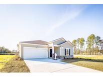 Charming one-story home featuring a two-car garage, neutral siding, and stone accents in a well-maintained community at 416 Ribbon Rail Way, Loris, SC 29569