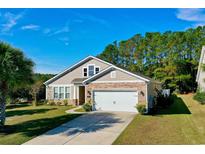 Attractive single-story home with a two-car garage and well-manicured lawn at 101 Hartwell Dr., Little River, SC 29566