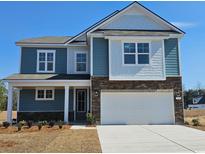Charming two-story home with blue siding, stone accents, and an attached two-car garage at 765 Choctaw Dr., Conway, SC 29526