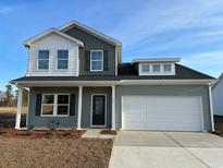Charming two-story home with a two-car garage and manicured lawn at 109 Arrow Wood Dr, Conway, SC 29526