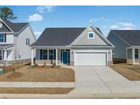 Charming single-story home with a well-manicured lawn, a two-car garage, and a welcoming blue front door at 2469 Campton Loop, Conway, SC 29527