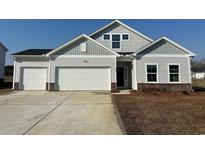 Charming single-Gathering home featuring a three-car garage and gray siding with brick detail at 316 Garden Grove St, Conway, SC 29526
