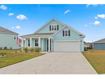 Charming two-story home with a two-car garage, covered porch and landscaped front yard at 4855 Guilford Loop, Myrtle Beach, SC 29588