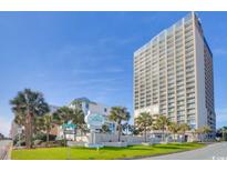 Condo complex with palm trees and manicured lawn on a sunny day at 5523 N Ocean Blvd. N # 1410, Myrtle Beach, SC 29577