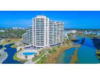 Stunning aerial view of an oceanfront condo building with a pool and scenic water views at 100 Ocean Creek Dr. # L5, Myrtle Beach, SC 29572