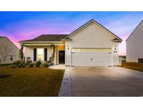 Charming house exterior featuring a two-car garage and well-manicured landscaping at 2022 Wilbraham Dr., Myrtle Beach, SC 29579