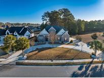 Stunning two-story home with a manicured front yard, circular driveway, and tasteful landscaping at 2207 Wood Stork Dr., Conway, SC 29526