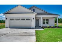 Charming single story home featuring an attached garage, green lawn, and traditional design elements at 2682 Hugo Rd., Conway, SC 29527