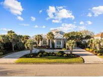 Stately home with lush landscaping, circular drive, and white tile roof at 3788 Waterford Dr., Myrtle Beach, SC 29577