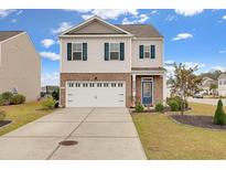 Charming two-story home featuring a blue front door, a brick-accented facade, and a spacious two-car garage at 568 Affinity Dr., Myrtle Beach, SC 29588