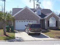 Charming single-story home with brick facade, attached garage, and well-maintained landscaping at 323 Sea Turtle Dr., Myrtle Beach, SC 29588