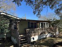 Charming single-story home featuring a covered porch, wood railings, and exterior shutters at 538 Calhoun Dr., Murrells Inlet, SC 29576