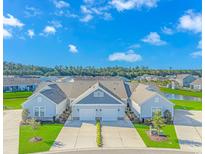 Charming townhomes with attached garages, manicured lawns, and beautiful landscaping near a pond at 830 San Marco Ct. # C, Myrtle Beach, SC 29579