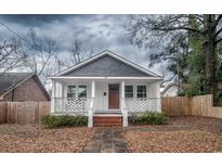 Charming home with white exterior, covered front porch, and landscaped yard at 108 N Hazard St., Georgetown, SC 29440