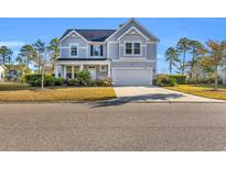 Charming two-story home with landscaped front yard and attached two-car garage at 217 Astoria Park Loop, Conway, SC 29526