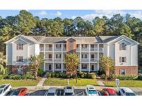 Multi-Gathering building featuring three stories, traditional architectural details, and multiple balconies at 4818 Innisbrook Ct. # 603, Myrtle Beach, SC 29579