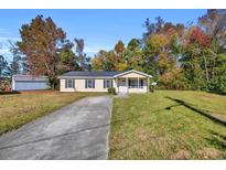 Charming single-story home with a well-maintained lawn and a classic front porch at 1960 Hampton St., Georgetown, SC 29440