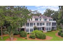 Stately exterior view showcasing a multi-story home with lush landscaping and a welcoming facade at 1969 Governors Landing Rd. # 224, Murrells Inlet, SC 29576